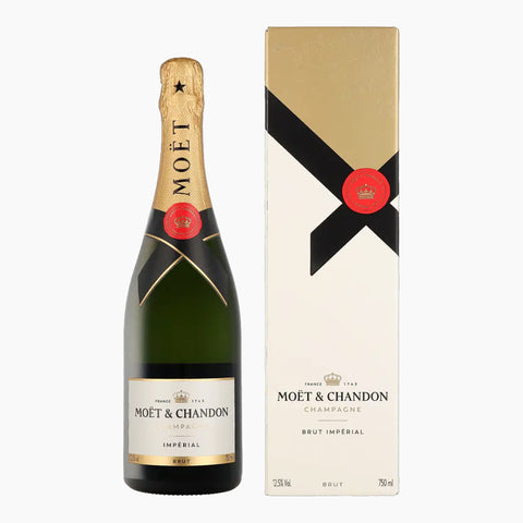 En flaske Moët & Chandon Impérial Brut Champagne + Gaveæske fra Moët & Chandon står ved siden af sin matchende cremefarvede og guldfarvede gaveæske med guldfolie på toppen og rødt segl på flasken.